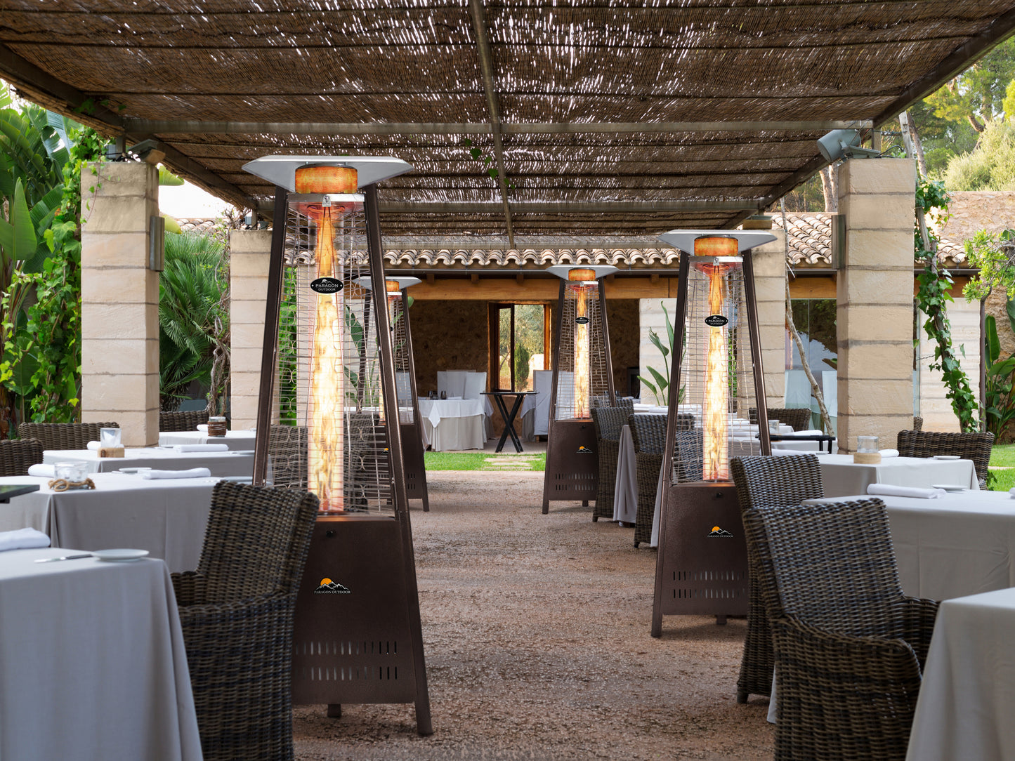 Multiple Boost Patio Heaters placed next to outdoor dining tables at an outdoor restaurant.