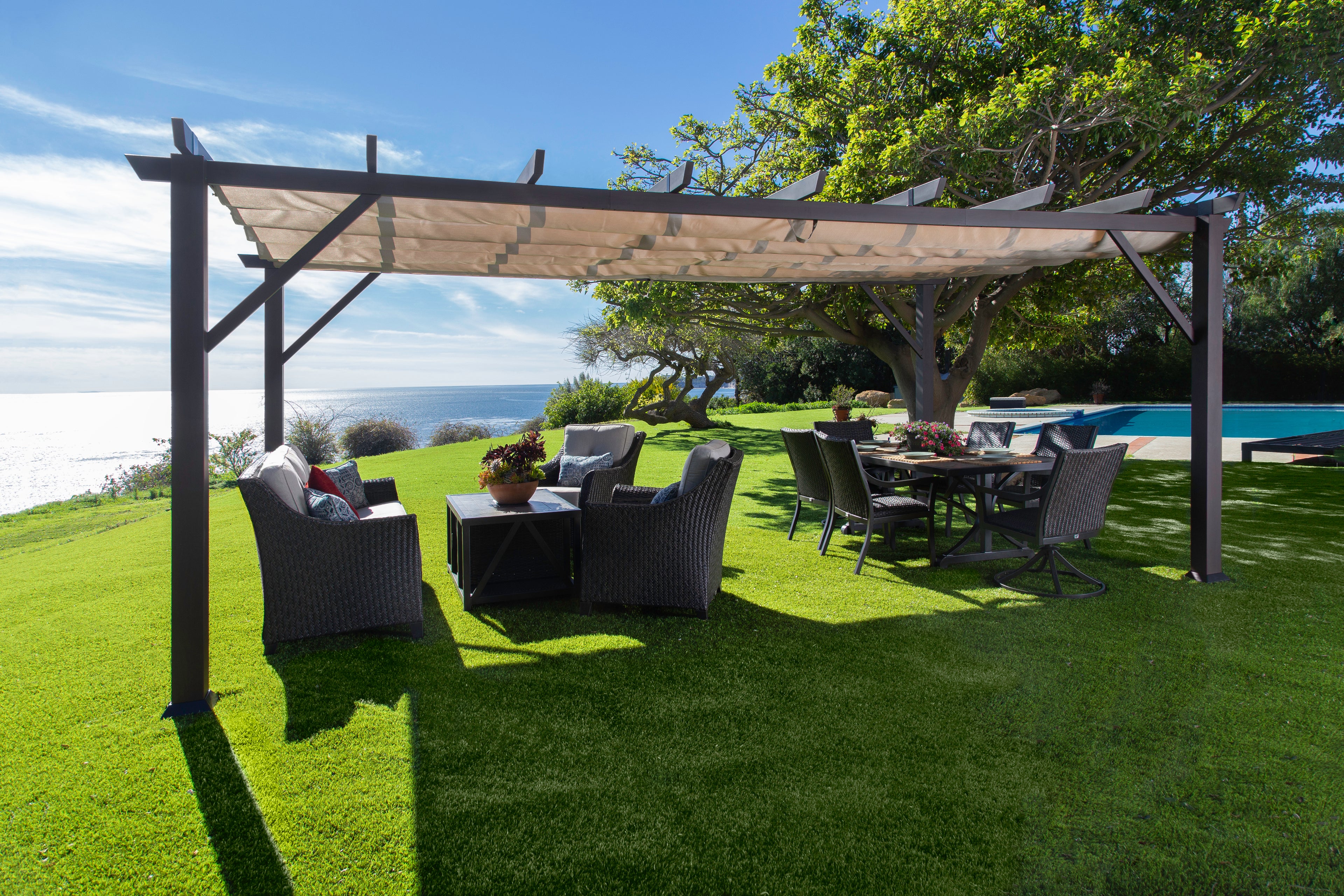 12' x 20' Modena Soft Top Pergola in backyard with outdoor furniture underneath