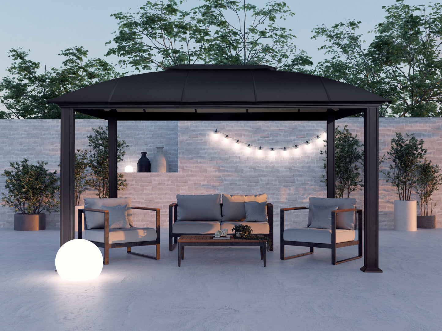 Cambridge Hard Top Gazebo at dusk with patio furniture and outdoor lighting underneath.
