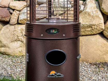 Close up of the Illume Patio Heater with digital control panel  in Hammered Bronze in backyard with rocks.