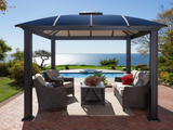Cambridge Hard Top Gazebo on brick patio with outdoor furniture underneath.