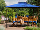Kingsbury Soft Top Gazebo in Mediterranean Blue Canopy Roof with outdoor dining table.